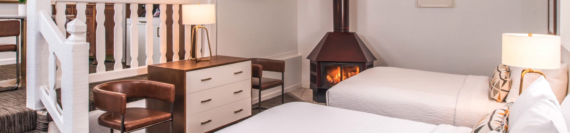 Bedroom with two beds and fireplace